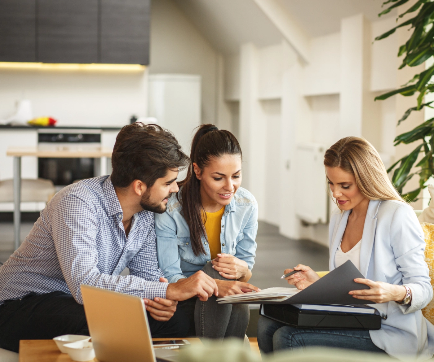Couple reviewing documents with agent.
