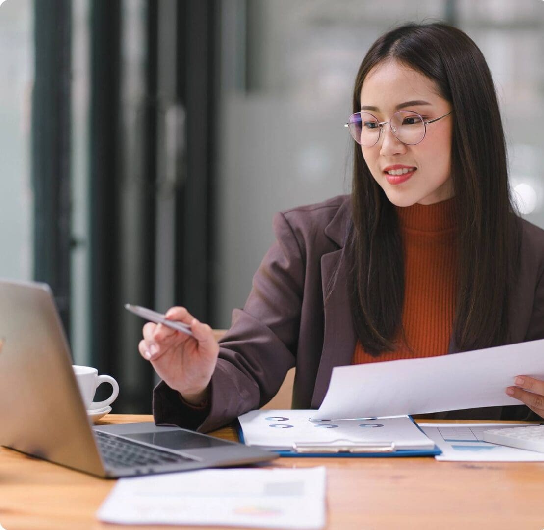 New Project (15) Businesswoman reviewing financial documents.